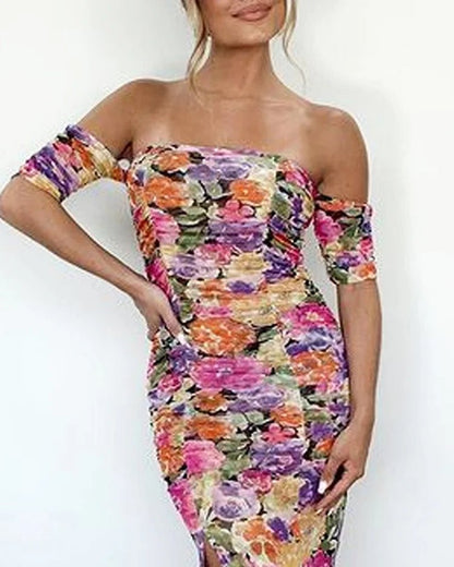 The dress features a mix of colors including purple, pink, orange, yellow, and green. The overall pattern is floral, creating a vibrant and colorful appearance.